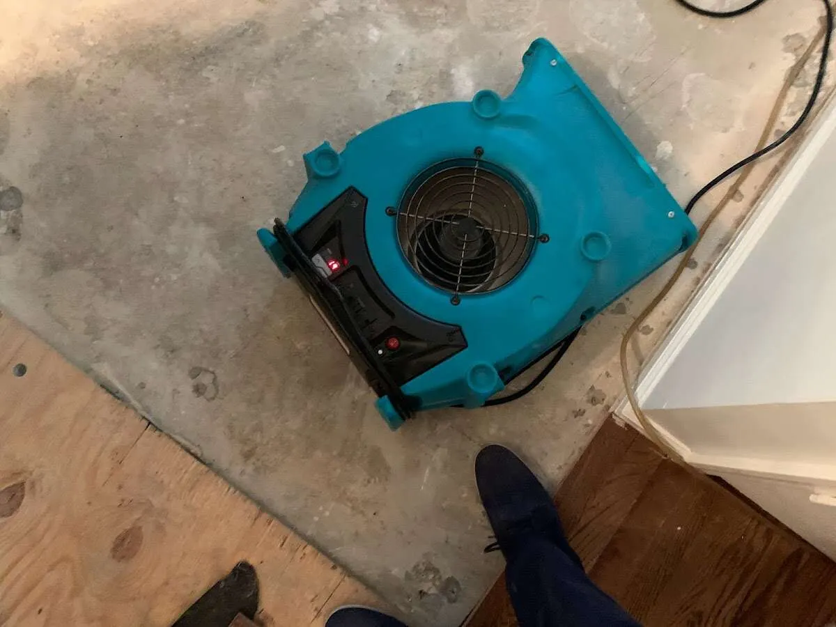 Air mover drying subfloor during Commercial Water Damage Restoration in Mountain Brook